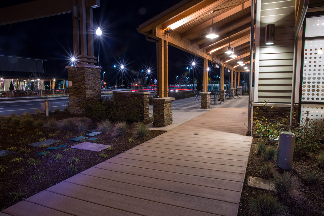 Photo of the Parkway Village sidewalk and parking lot at night