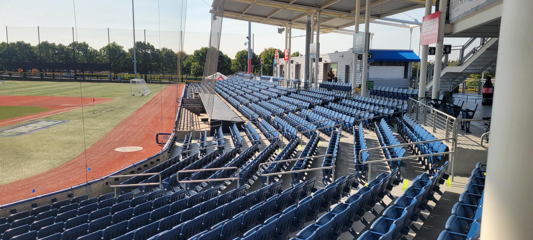 Rows of stadium seating and a ball field at the Hillsboro Hops Stadium