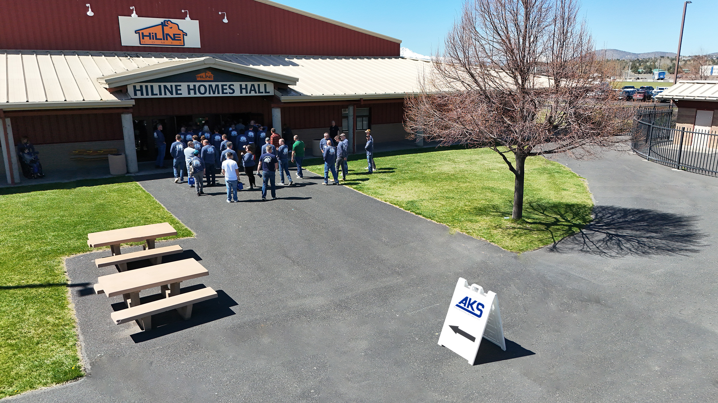 Drone photo captured by AKS Engineering & Forestry’s in-house Aerial Surveying team, showing employees arriving at the Deschutes County Fairgrounds in Redmond, Oregon for Camp AKS 2025 — the company’s annual retreat focused on civil engineering careers, mentorship, and team culture.